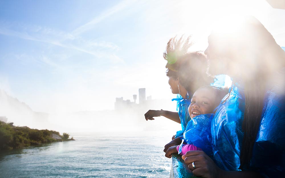 Family on the shore of Niagara Falls in Buffalo NY.